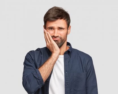 Smart boy suffering from tooth pain and looking to visit a dentist in Malton for dental emergency.