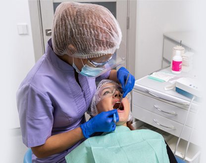Dentist in Mississauga performing dental exam and cleaning on patient.